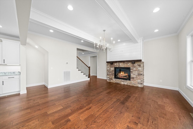 unfurnished living room featuring a fireplace, a notable chandelier, visible vents, dark wood-type flooring, and stairs