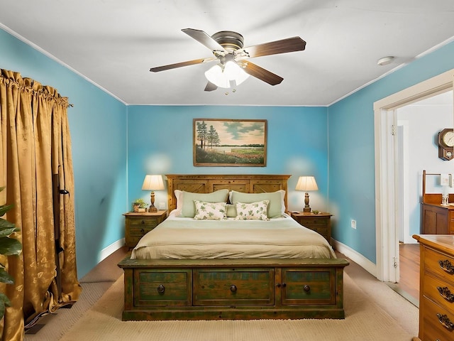 carpeted bedroom featuring baseboards, ceiling fan, and crown molding