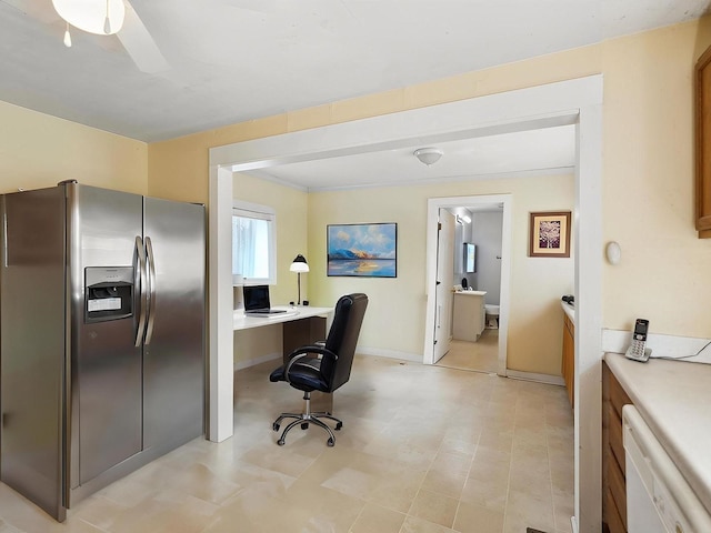 home office with ceiling fan, light floors, and baseboards
