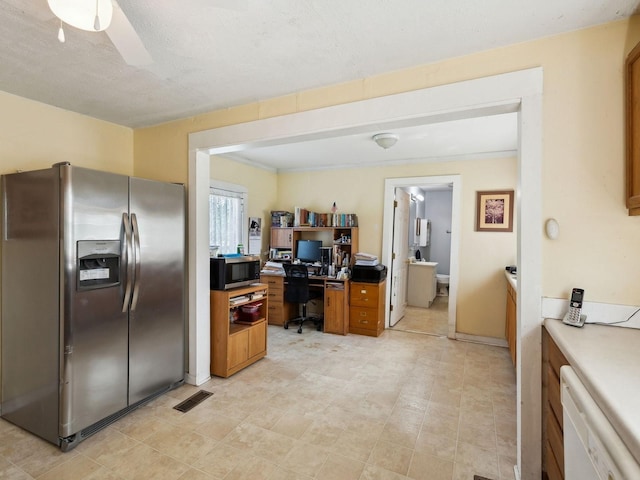 kitchen featuring appliances with stainless steel finishes, visible vents, brown cabinetry, and ceiling fan