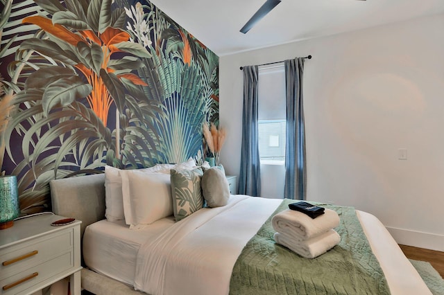 bedroom with baseboards and wood finished floors