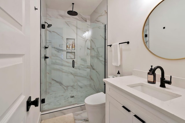 full bath with vanity, toilet, a marble finish shower, and marble finish floor