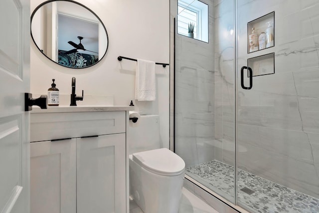 full bathroom with vanity, toilet, a shower stall, and ceiling fan