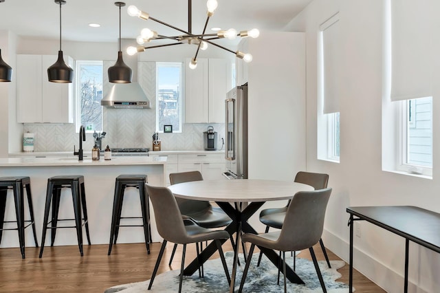 dining room with a chandelier and wood finished floors