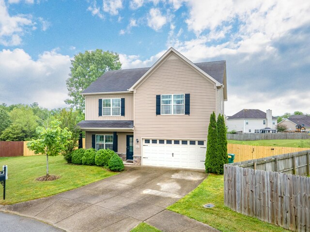 5002 Fox Run S, Spring Hill, TN 37174 - traditional-style home featuring driveway, a front yard, fence, an attached garage, and stone siding