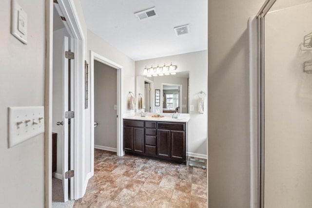 5002 Fox Run S, Spring Hill, TN 37174 - bathroom featuring a sink, double vanity, baseboards, and visible vents