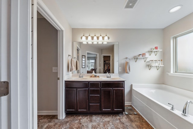 5002 Fox Run S, Spring Hill, TN 37174 - full bath with a sink, a garden tub, baseboards, and visible vents