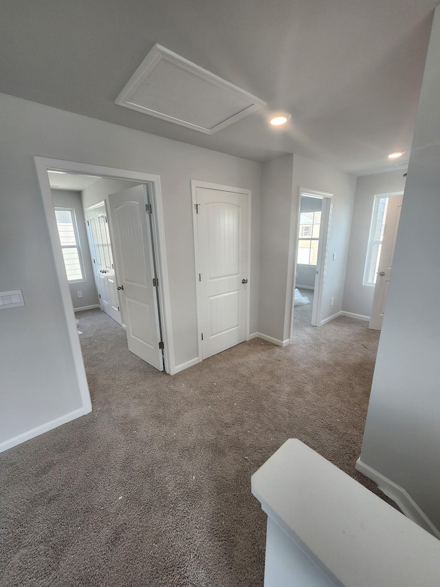 interior space featuring carpet flooring, baseboards, and recessed lighting