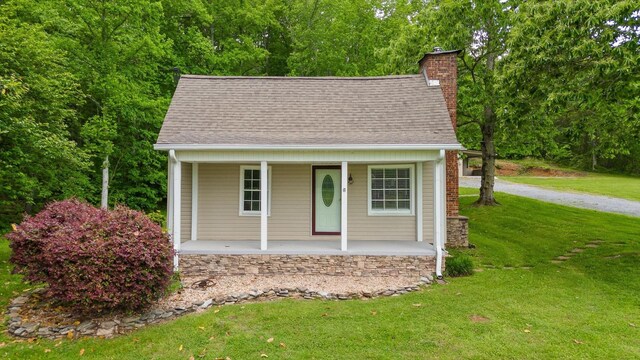 455 No Pone Valley Rd NW, Georgetown, TN 37336 - view of front of property with a chimney, a porch, roof with shingles, and a front lawn