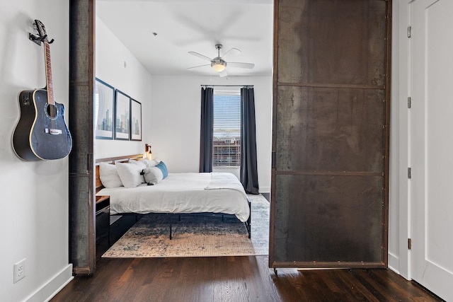 bedroom with wood finished floors, baseboards, and ceiling fan