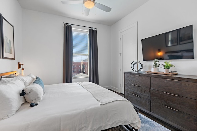 bedroom with wood finished floors and baseboards