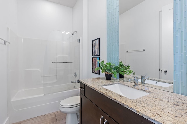 bathroom featuring vanity, toilet, shower / tub combination, and wood finished floors