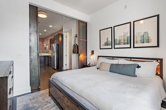 bedroom featuring freestanding refrigerator, dark wood-style flooring, baseboards, and recessed lighting