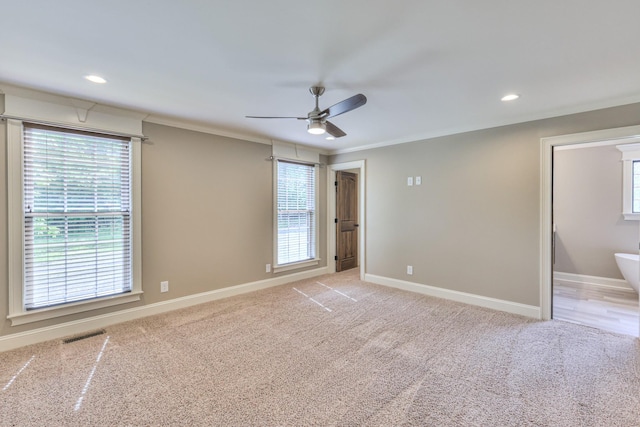 interior space featuring light colored carpet, plenty of natural light, a ceiling fan, and recessed lighting
