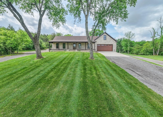 ranch-style house featuring a front yard, driveway, and a garage
