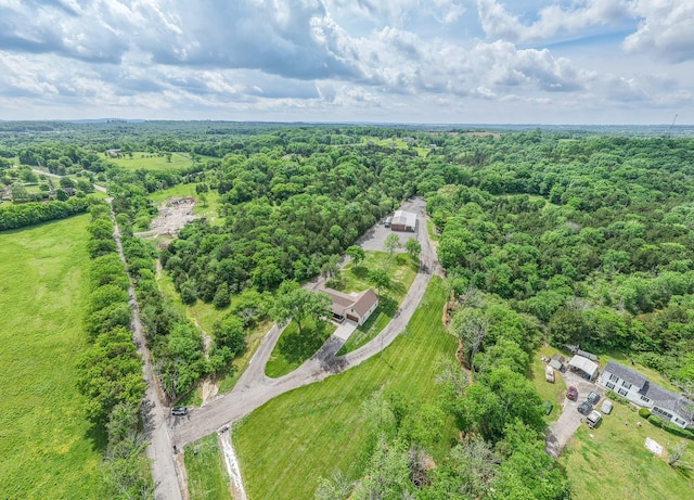 drone / aerial view featuring a forest view