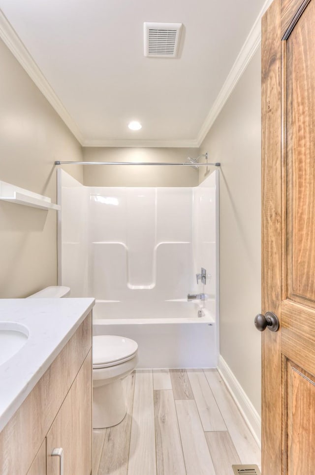 bathroom with toilet, wood finished floors, visible vents, crown molding, and  shower combination