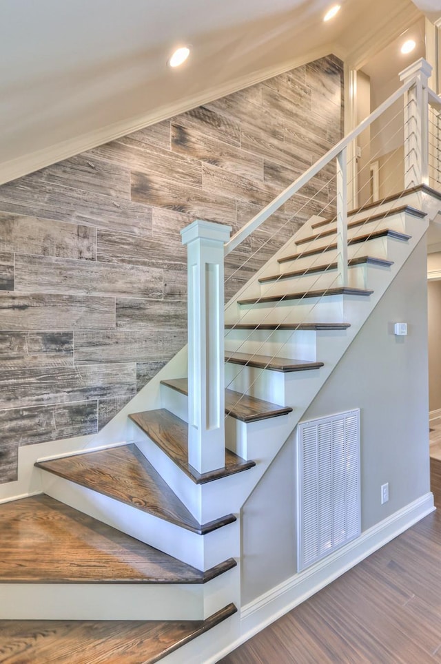 staircase with visible vents, wood finished floors, lofted ceiling, and recessed lighting