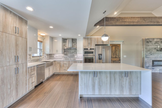 kitchen with stainless steel appliances, lofted ceiling with beams, wall chimney exhaust hood, light brown cabinets, and modern cabinets