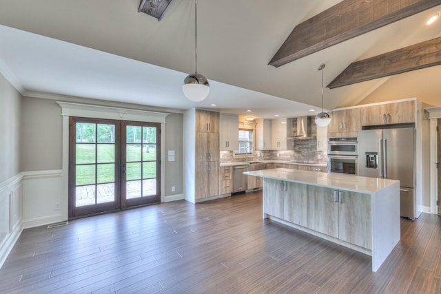 kitchen with french doors, wall chimney exhaust hood, modern cabinets, light countertops, and appliances with stainless steel finishes
