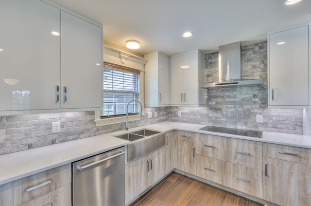 kitchen with a sink, light brown cabinetry, wall chimney exhaust hood, stainless steel dishwasher, and modern cabinets