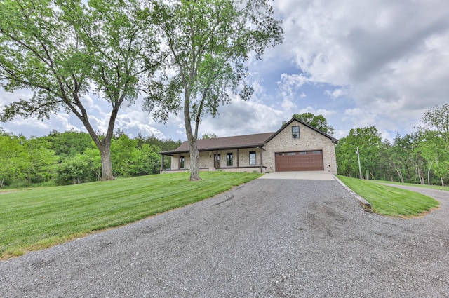 ranch-style house featuring driveway, brick siding, an attached garage, and a front yard