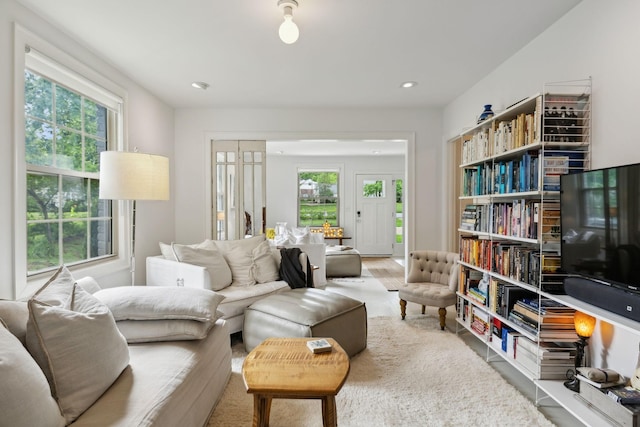 living room featuring plenty of natural light, wood finished floors, and recessed lighting