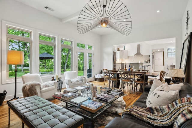 living room with recessed lighting, french doors, visible vents, and wood finished floors