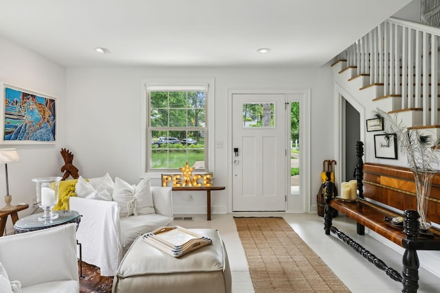 living area with recessed lighting, stairway, visible vents, and tile patterned flooring