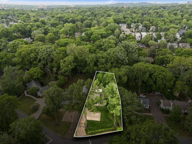 birds eye view of property featuring a view of trees