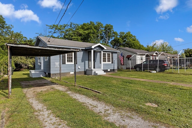 view of front of house with fence, a front yard, and a carport