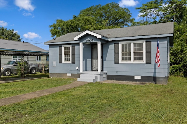 bungalow-style home featuring a carport, a front lawn, and crawl space