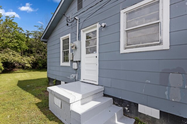 property entrance with a yard