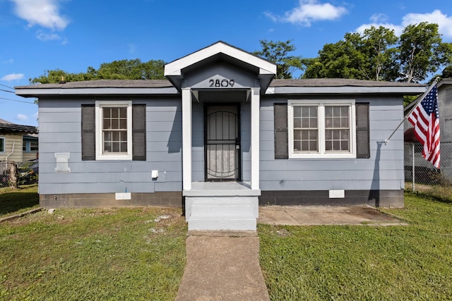 bungalow-style house featuring crawl space, fence, and a front yard