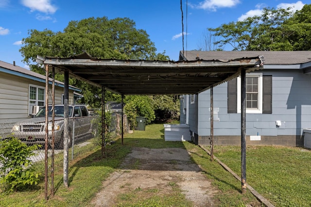 view of car parking with a detached carport and fence