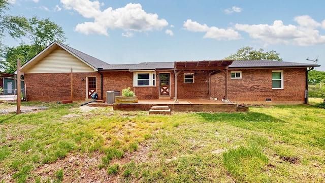 rear view of property featuring a yard, brick siding, a patio area, a pergola, and central AC unit