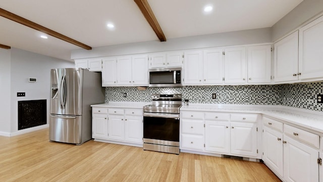 kitchen with beam ceiling, stainless steel appliances, and white cabinetry