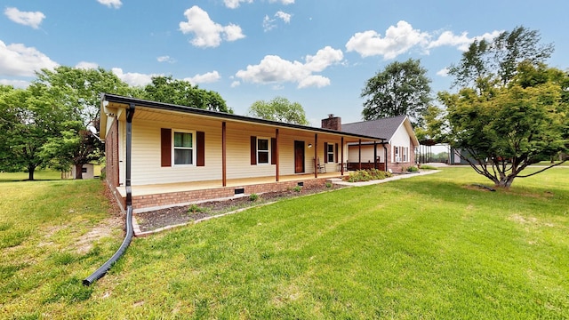 view of front facade with covered porch, a chimney, and a front lawn