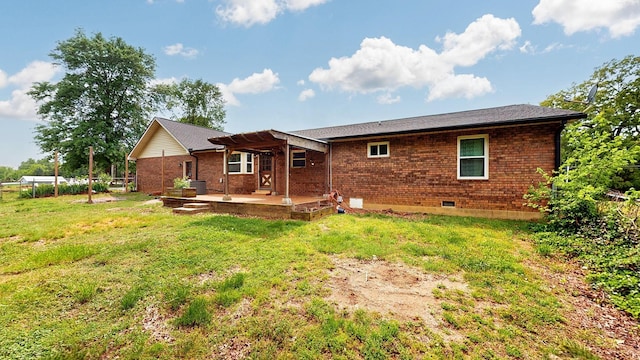 back of house with a yard, brick siding, a patio, and a pergola