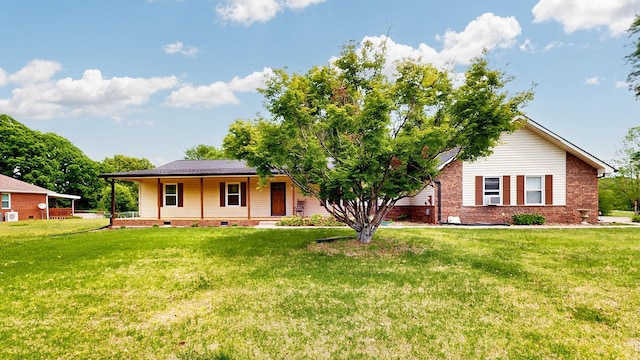 view of front facade featuring a porch, a front yard, brick siding, and crawl space