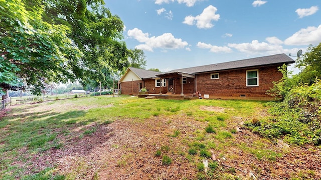 back of house with a patio area, fence, brick siding, crawl space, and a yard