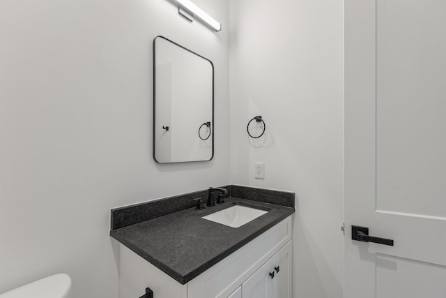 bathroom with toilet and vanity