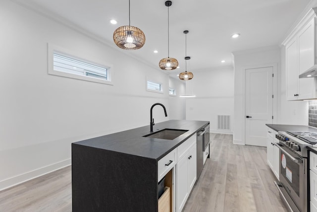 kitchen featuring a sink, dark countertops, visible vents, and appliances with stainless steel finishes