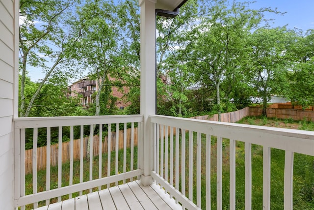 wooden terrace featuring fence