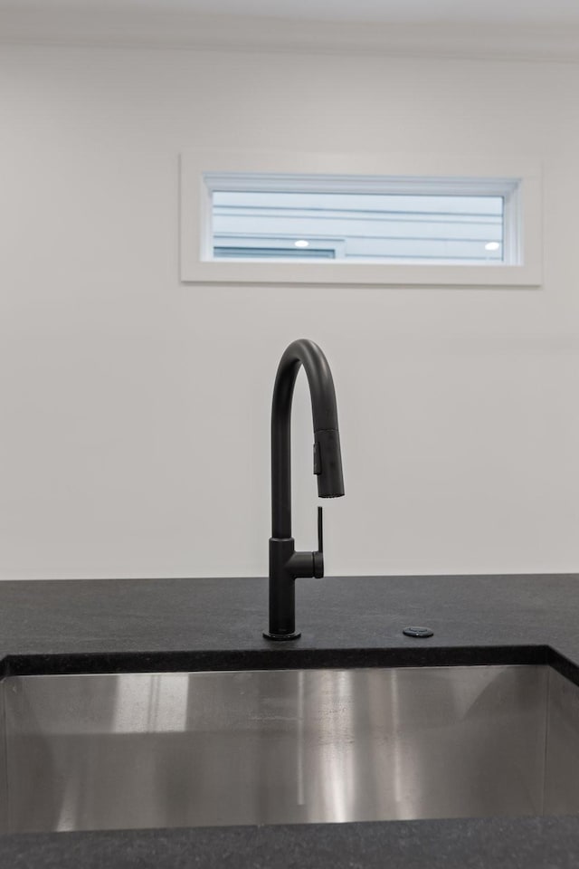 details with a sink and dark countertops