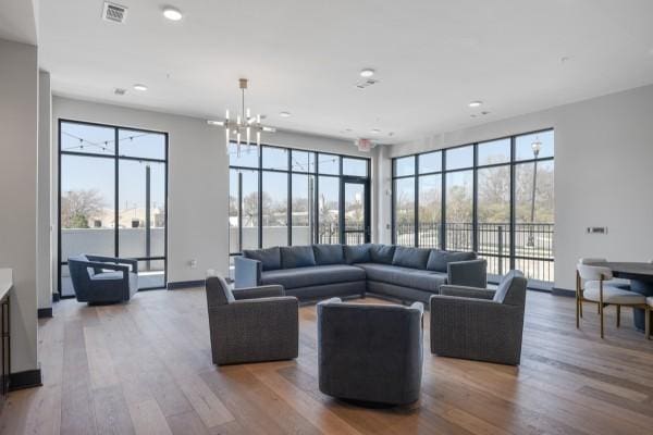 1677 54th Ave N Unit 318, Nashville, TN 37209 - living room featuring wood finished floors, healthy amount of natural light, recessed lighting, a chandelier, and baseboards