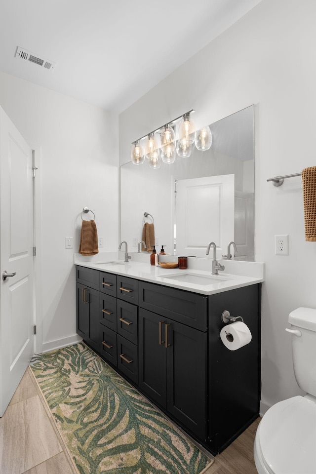 1677 54th Ave N Unit 318, Nashville, TN 37209 - bathroom with double vanity, toilet, and baseboards