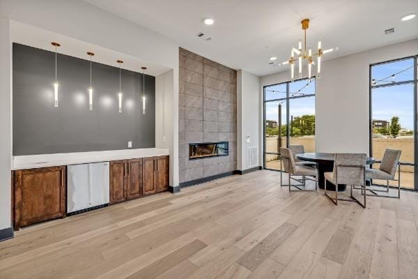 1677 54th Ave N Unit 318, Nashville, TN 37209 - living area with healthy amount of natural light, light wood-type flooring, a fireplace, a chandelier, and recessed lighting