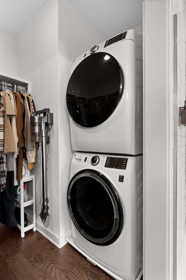 1677 54th Ave N Unit 318, Nashville, TN 37209 - laundry room featuring stacked washer and clothes dryer, wood finished floors, and baseboards