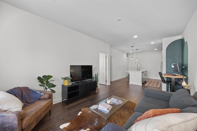 1677 54th Ave N Unit 318, Nashville, TN 37209 - living room featuring dark wood-style floors, baseboards, recessed lighting, and arched walkways